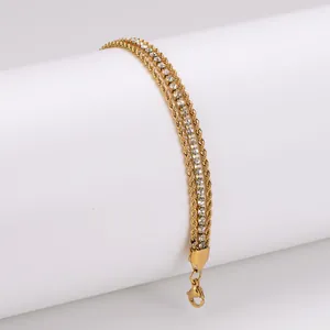 Detail of a triple-layer 18K gold plated bracelet with rope chain and white CZ.