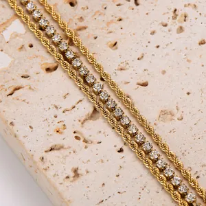 Macro detail of 18K gold plated triple layer bracelet with rope chain and white zirconia