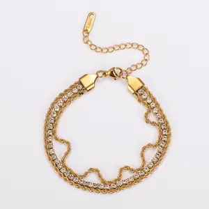 Macro detail of 18K gold plated three-strand bracelet with twisted rope and white zircons.