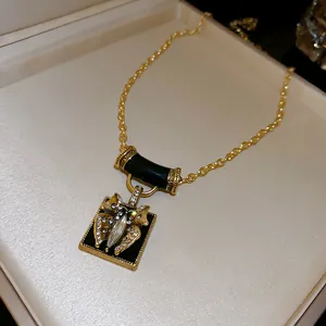 Macro view of a vintage gold necklace featuring an exquisite crystal butterfly pendant