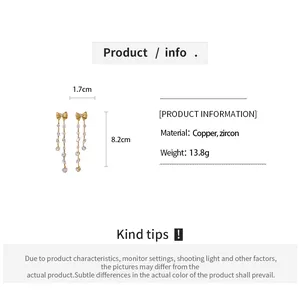 Close-up of gold bow tassel earrings with dimensions and product specifications