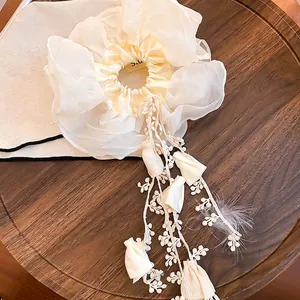 Elegante scrunchie color crema a strati con lunghe nappe in pizzo e piume soffici