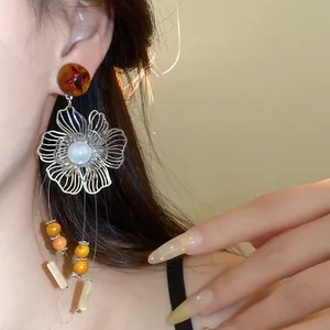 Detailed view of vintage silver needle flower tassel earrings with resin and pearls