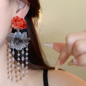 Detailed view of handmade resin flower tassel earrings in New Chinese retro style worn by model