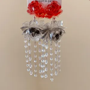 Detailed macro view of vintage resin stained flower earrings with delicate bead tassels.