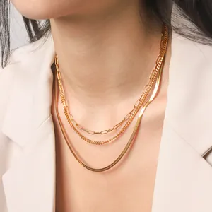 Detail of three-layer gold-plated stainless steel necklaces with different chain styles