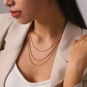 Model wearing 18K gold plated three-layer stacked stainless steel chain necklaces.