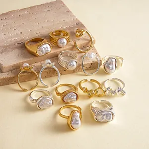 Detailed view of various retro irregular geometric gold and silver rings with faux pearls