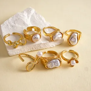 Close-up of 7pcs vintage gold rings set featuring irregular pearls and floral designs.