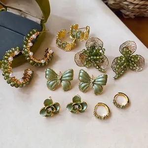 Exquisite collection of forest-style green and gold earrings with floral and butterfly designs
