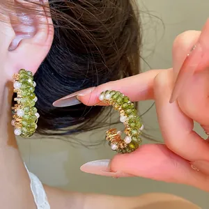 Elegant green crystal and pearl C-shaped hoop earrings for a forest style look