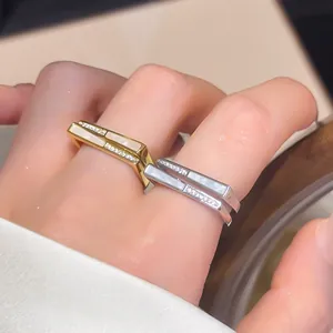 Macro detail view of minimalist square open rings with shell inlay and sparkling zirconia