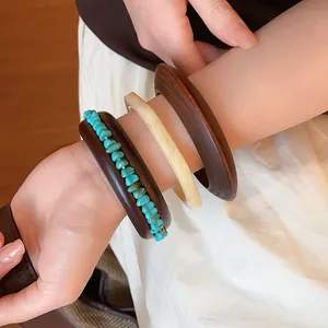 Detail view of retro resin and wood bangle set worn on wrist in Maillard style
