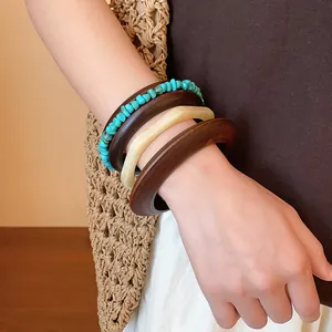 Close-up of vintage Maillard style geometric resin and turquoise bead bangle set