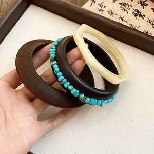 Close-up of vintage resin bangle set featuring turquoise stones and marbled textures