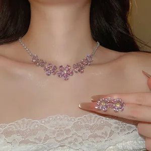 Close-up of elegant pink floral cubic zirconia necklace and earring set on model