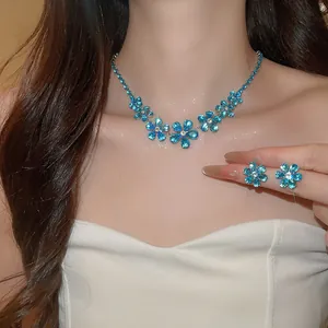 Elegant jewelry set with blue zircon flower necklace and earrings worn by a model for a party