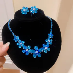 Close-up of sparkling blue zircon flower necklace and earrings jewelry set for women