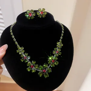 Detailed shot of sparkling green zircon floral jewelry set on black velvet stand