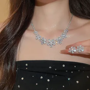 Close-up of sparkling flower zircon necklace and earrings set on an elegant model