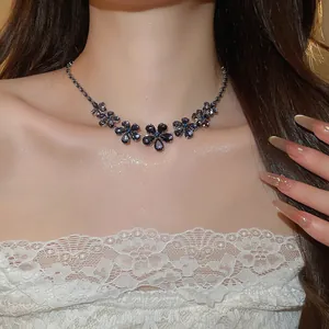 Close-up of floral zircon necklace on model featuring purple flower pendants