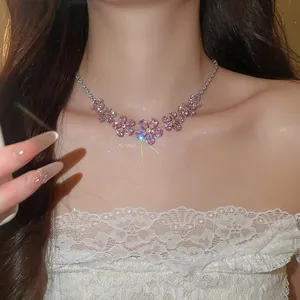 Detailed view of elegant pink zirconia flower pendant necklace on model for evening dress