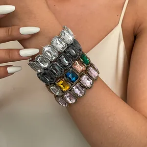 Close-up of several vintage stretch bracelets with large colorful geometric rhinestones.