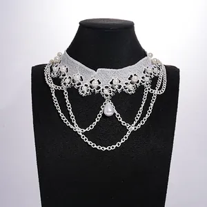 Nahaufnahme eines weißen Spitzen-Chokers mit Perlenbesatz und mehrlagigen Ketten