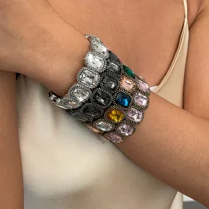 Close-up of stacked retro square crystal elastic bracelets on model's wrist