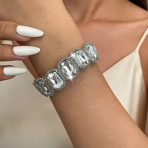 Detailed close-up of a sparkling silver elastic bracelet with large square crystals.