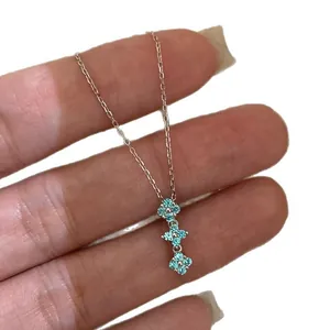 Elegant minimalist necklace featuring three sparkling blue zircon flower pendants on a thin chain