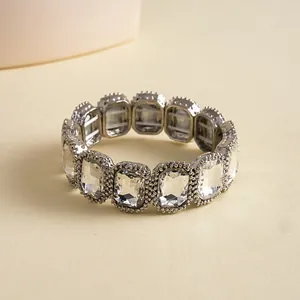 Close-up of vintage silver-tone stretch bracelet featuring radiant square-cut crystals.