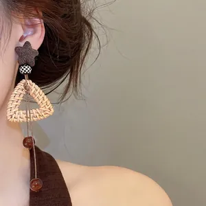 Bohemian rattan triangle drop earrings with star stud and checkered bead detail