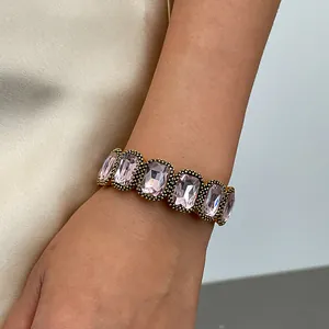 Elegant vintage style square pink gemstone elastic bracelet worn on a woman's wrist