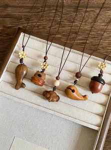 Gedetailleerde weergave van handgesneden houten kettingen met dierenhangers