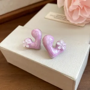 Detailed close-up showing the texture of purple marble heart earrings with resin flowers