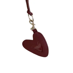 Minimalist burgundy leather heart pendant necklace with silver clasp on white background