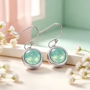 Detailed close-up of stainless steel hook earrings with faceted mint green zircon stones