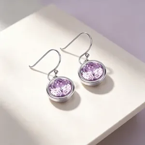 Detailed view of stainless steel lavender zirconia drop earrings on a white stand
