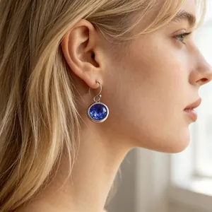 Detailed close-up of elegant stainless steel earrings with sparkling blue round zirconia