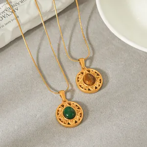 Close-up of vintage sunflower pendants with green and brown natural stones.