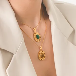 Close-up of vintage sunburst necklaces with green and tiger eye stones on model.