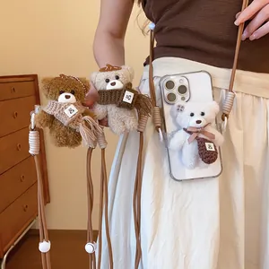 Detail view of cute plush teddy bear pendants in brown, beige, and white colors