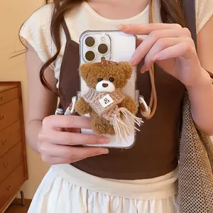 Detailed close-up view of a cute plush brown bear accessory attached to a mobile phone case