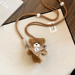 Close-up of cute plush bear pendant necklace with brown adjustable cord