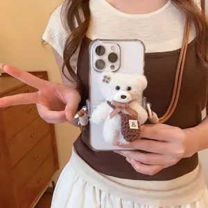 Close-up detail of a cute white plush bear phone holder accessory on a transparent case