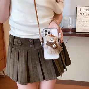 Detailed shot of a cute plush teddy bear accessory attached to a clear phone case