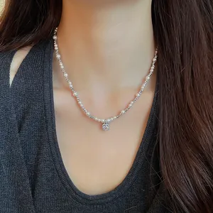 Elegant faux pearl necklace with a sparkling square zircon pendant worn by model