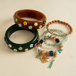 Vintage resin flower bangles and heart beaded charm bracelets set in a bohemian style.