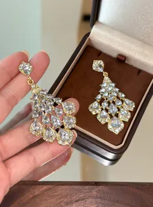 Close-up of vintage chandelier teardrop earrings with sparkling crystal rhinestones.